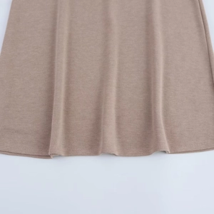 Close-up of ribbed knit texture and hemline on earth-toned midi skirt and top set
