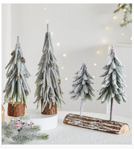 Detail of mini snowy Christmas trees with PE pine needles and wooden base for holiday decor