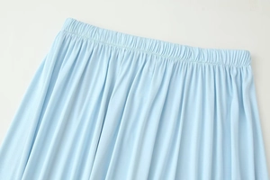 Detail of light blue high waist elastic waistband with draped fabric texture