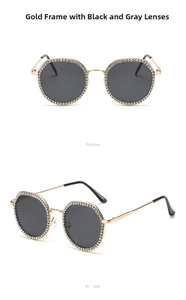 Detail of gold frame sunglasses with sparkling rhinestones and black-gray lenses
