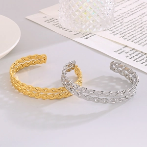 Detailed view of woven twisted rope open bangles in gold and silver finish