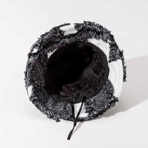 Detail view of plaid wool bucket hat featuring frayed edges and soft fabric lining