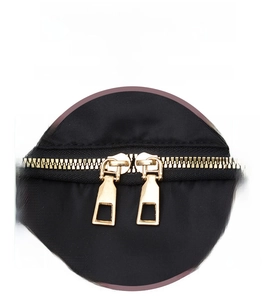 Detail of high-density black nylon fabric with premium golden dual zippers and hardware