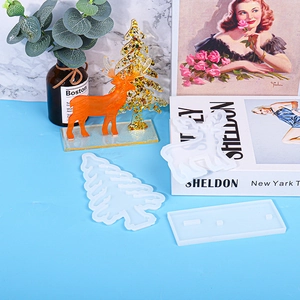 Christmas DIY resin molds set including reindeer and tree shapes on blue background