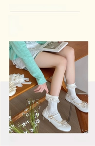 Detailed view of white ballet-style lace ruffle socks paired with Mary Jane bow shoes