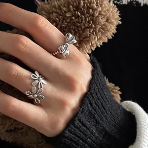 Vintage hollow flower and bow open ring set in polished silver metal for women