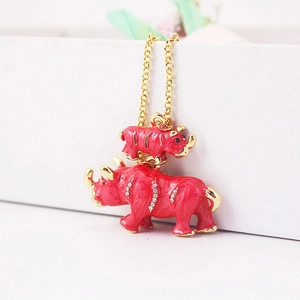 Sparkling rhino pendant necklace with red enamel and gold trim on white box