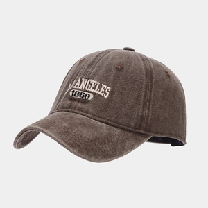 Close-up of vintage washed brown cotton baseball cap with cream ANGELES 1860 embroidery