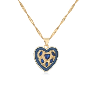 Close-up of heart pendant necklace with gold chain and blue gems on white background