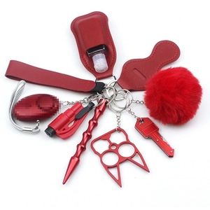 Red self-defense keychain set with wristlet, alarm, and protective tools on white background