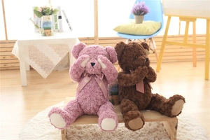 Detail of pink and brown plush teddy bears with rose swirl texture and cute bows