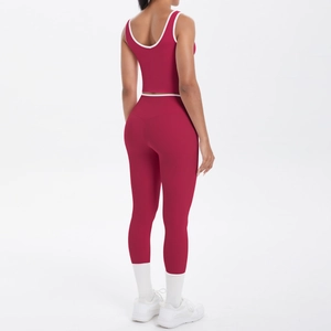 Detail view of burgundy yoga set with high waist leggings and contrast white trimming