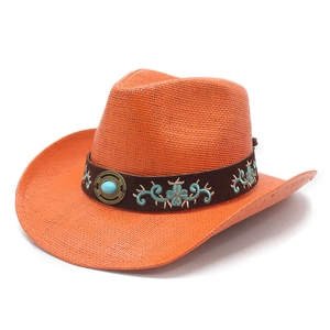 Detail of orange straw western cowboy hat with brown leather band and turquoise buckle
