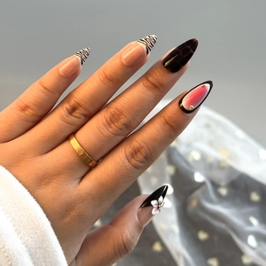 Detailed view of handmade press-on nails with zebra patterns and 3D floral accents