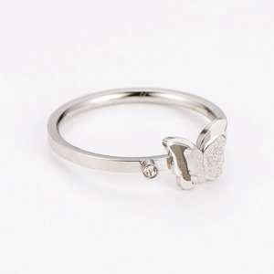 Macro detail of silver butterfly ring with sparkling wings and single zircon inlay