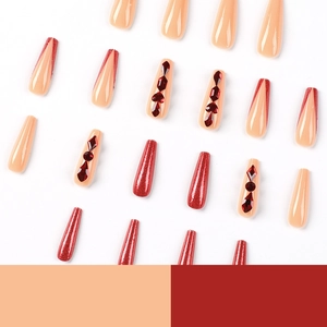 Long coffin press-on nails with red glitter gradient and rhinestones for elegant styling