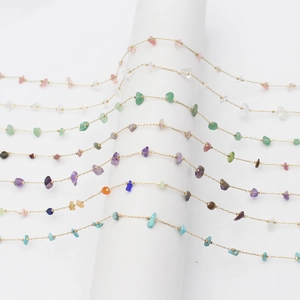 Minimalist gold sunglasses chains featuring natural colorful crushed stones on white stand