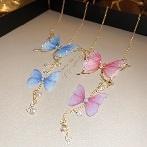 Elegant butterfly tassel necklace with rhinestones and pearls in blue and pink tones