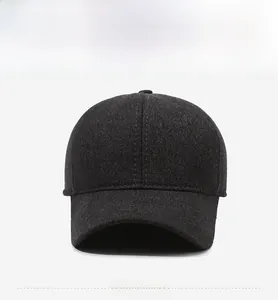 Detail of grey wool baseball cap showing silver Sports Style badge and textured fabric