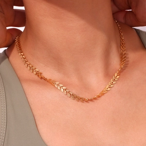 Close-up of 18K gold plated leaf pendant necklace featuring detailed textured veins