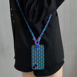 Detail of woven crossbody strap and geometric pattern phone case for iPhone