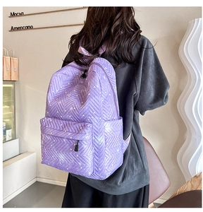 Detalle de la mochila acolchada morada con diseño de corazones blancos y cremalleras negras