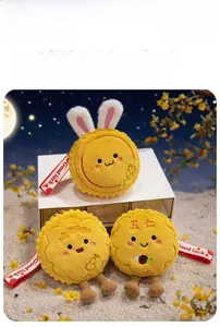 Close-up of plush mooncake pendants with cute bunny ears and Good Luck red straps