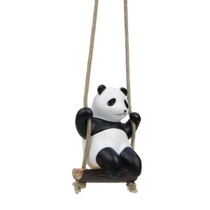 Detailed view of creative panda resin ornament swinging on a textured brown wooden board