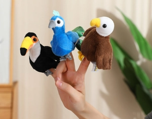Close-up of bird-themed plush finger puppets including toucan, blue bird, and eagle styles
