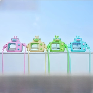 Detail of creative TV-shaped water bottles with bunny ears and woven straps in a box