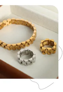 Detail of gold and silver watch band style jewelry set with brushed metal texture