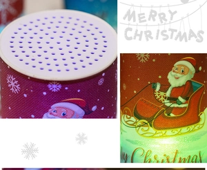 Detail view of purple Christmas Bluetooth speaker with Santa Claus print and LED lights