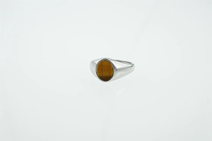 Macro view of silver titanium steel ring with an oval brown tiger eye stone inlay