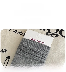 Close-up of ribbed cuffs on dark grey cotton blend socks with elastic knit structure