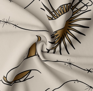 Macro view of sun and moon printed fabric texture showing soft weave detail and draping