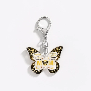 Macro detail of butterfly acrylic keychain with golden metal ring and Mom gift text