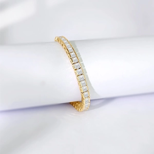 Macro shot of gold-plated tennis bracelet with square-cut cubic zirconia crystals