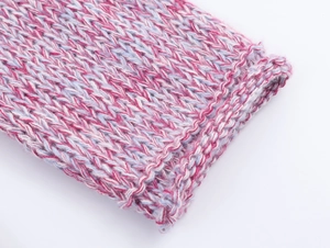 Macro shot of pink and light blue gradient knit fabric showing thick yarn texture