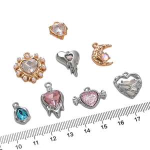 Mixed alloy pendants with colorful rhinestones and pearls, shown with a ruler for scale