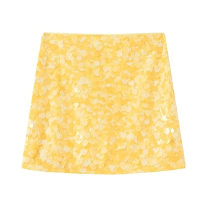 Fashionable bright yellow sequin mini skirt presented in a clean flat lay on white background