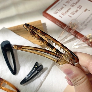 Close-up of minimalist resin duckbill hair clips with non-slip serrated teeth design