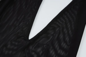 Close-up of black elastic mesh fabric texture and sheer net stitching on the dress