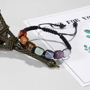 Handmade chakra energy bracelet with natural stones on a bronze decorative tower