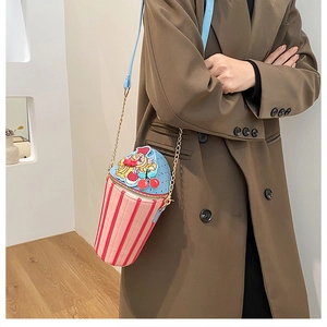 Creative ice cream shape crossbody bag with metal chain on model with brown coat