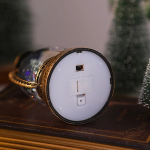Macro detail of Christmas lantern base featuring the power switch and battery compartment
