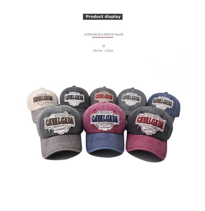 Detail of vintage washed baseball cap featuring intricate embroidery and distressed edges