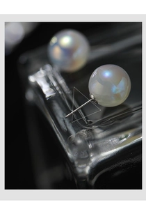 Macro shot showing the S925 hallmark on the silver needle of the pearl earring