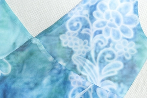 Detailed macro view of the breathable blue floral mesh fabric texture and pattern