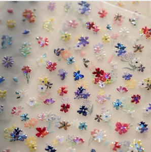 Detailed view of 3D floral nail stickers featuring a pearlescent shell light finish