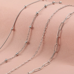 Silver stainless steel chain necklace set featuring snake, ball, and paperclip links